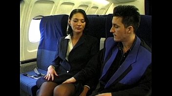 Brunette beauty wearing stewardess uniform gets fucked on a plane